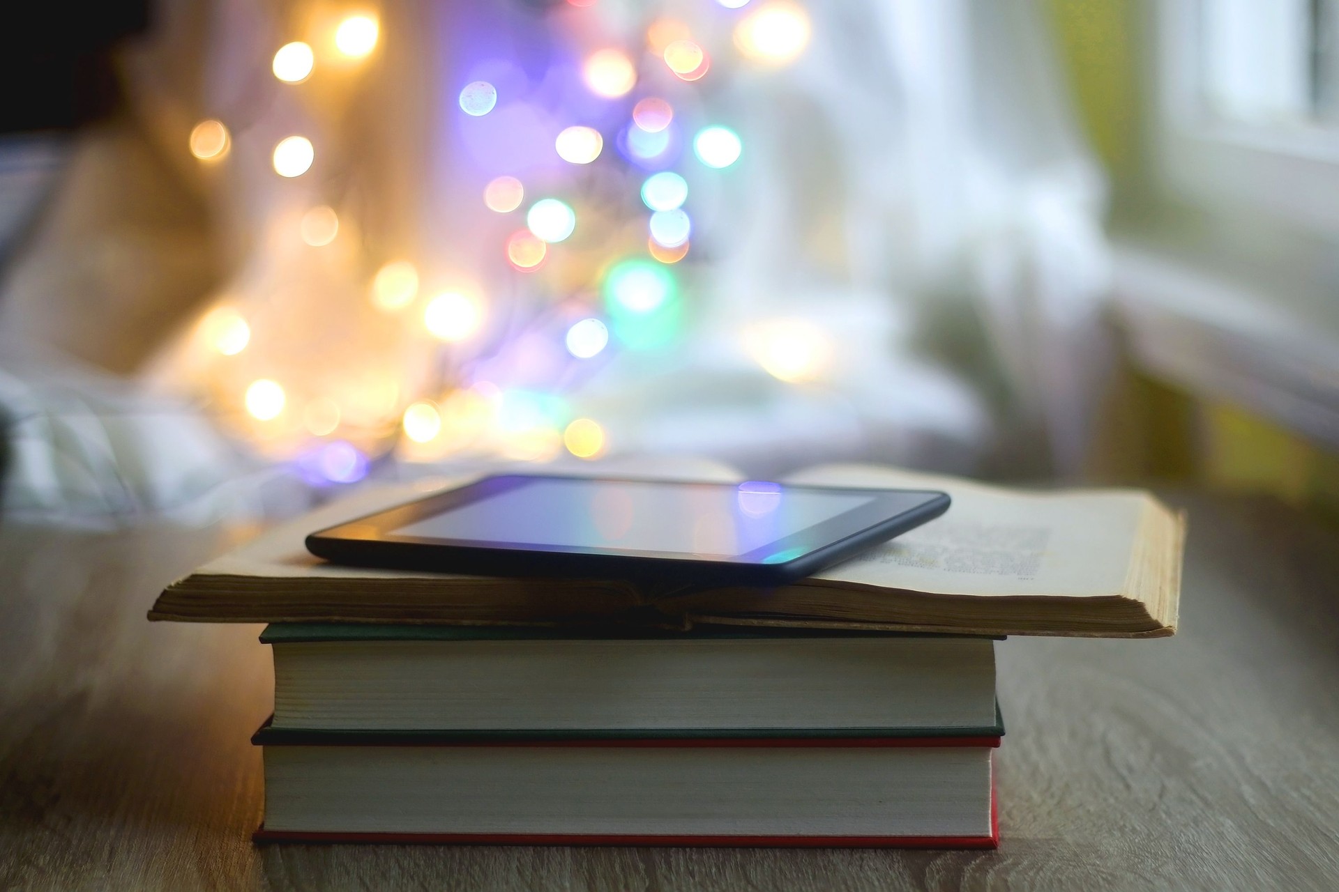Books, E-Reader and Colorful Bokeh