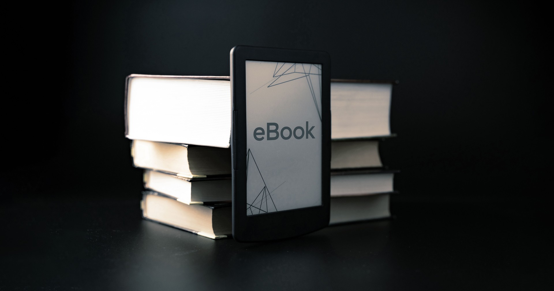 E reader. Digital e book, library reader tablet with books on dark background. Online education course, E learning class and ebook digital technology concept.